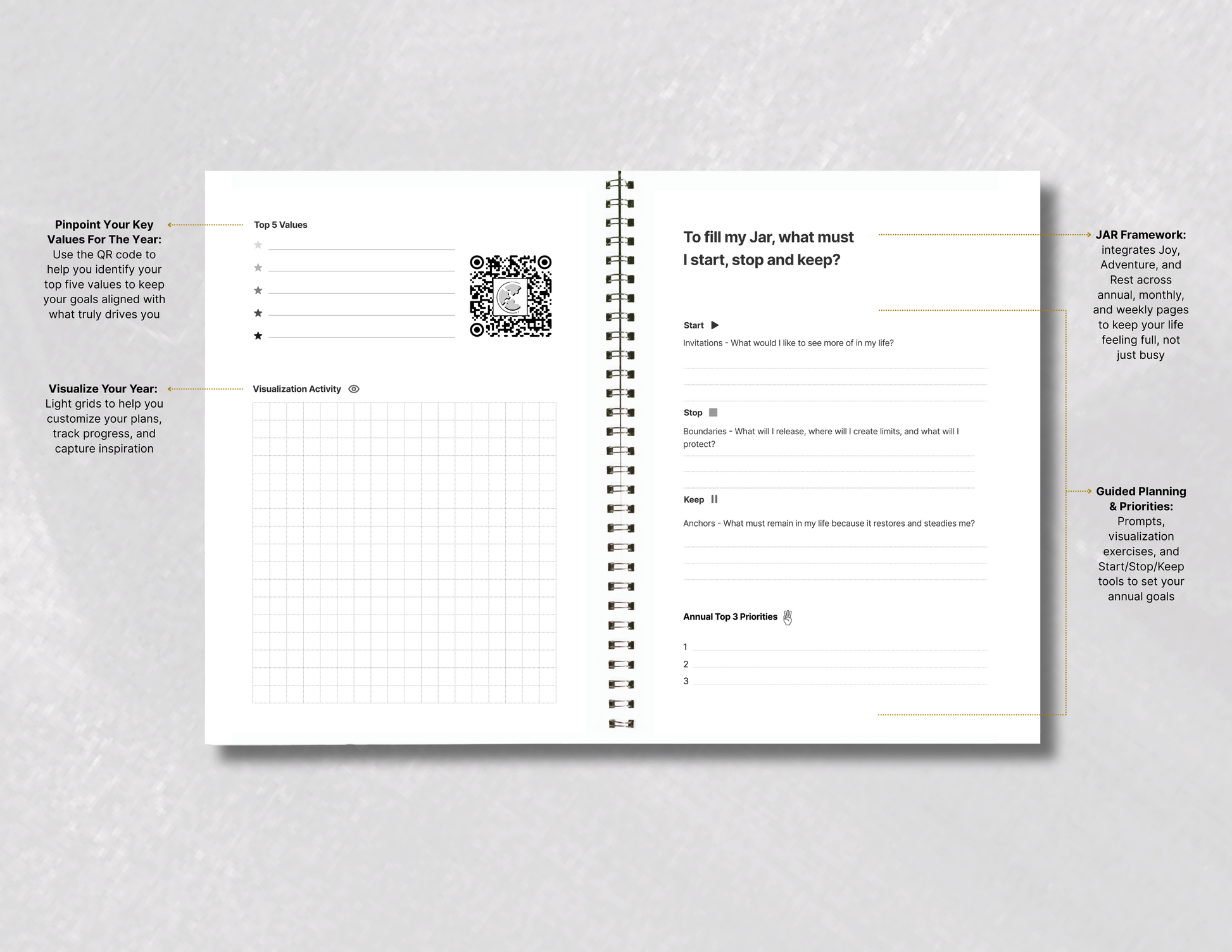 Spiral-bound planner with open pages on a gray background