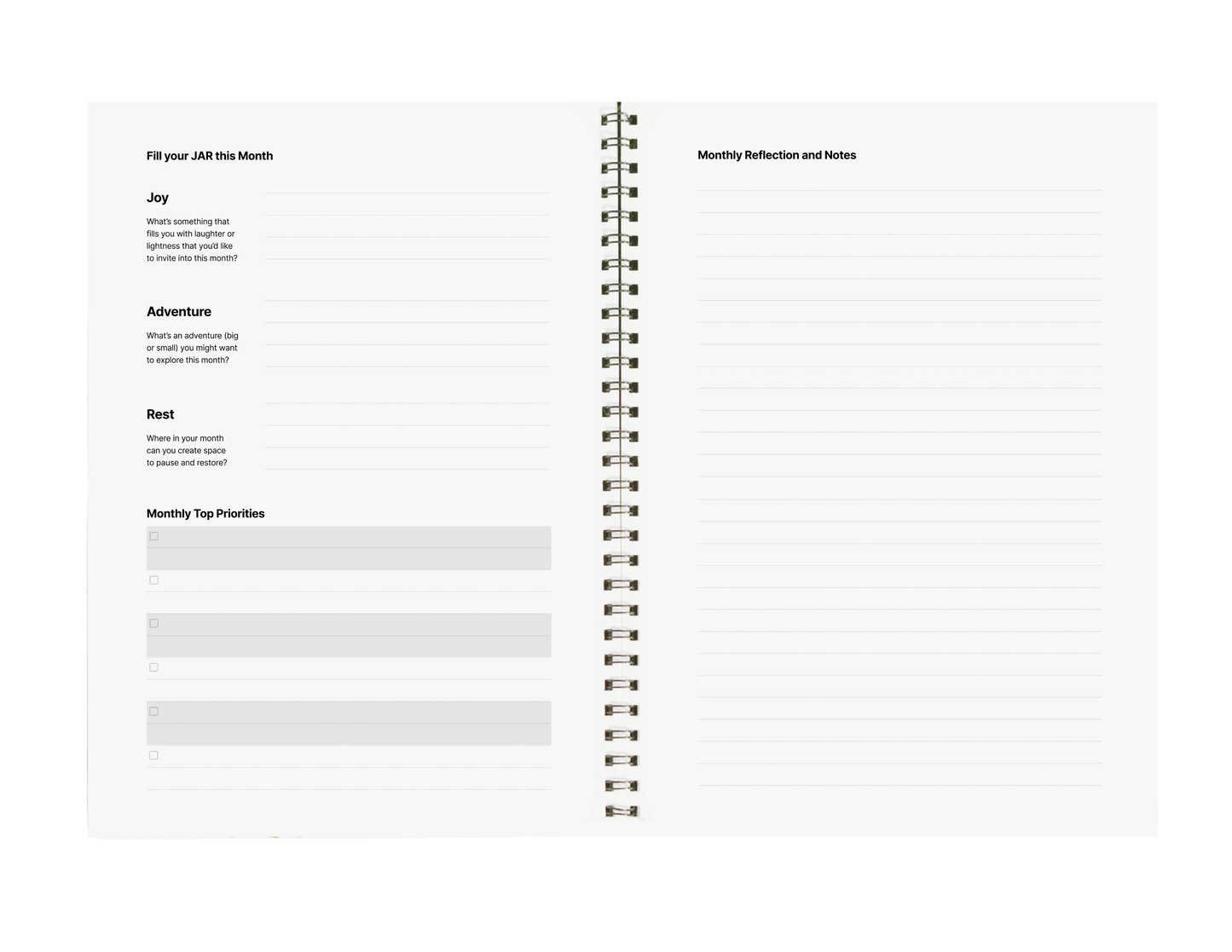 Spiral-bound planner with reflection and notes pages on a white background